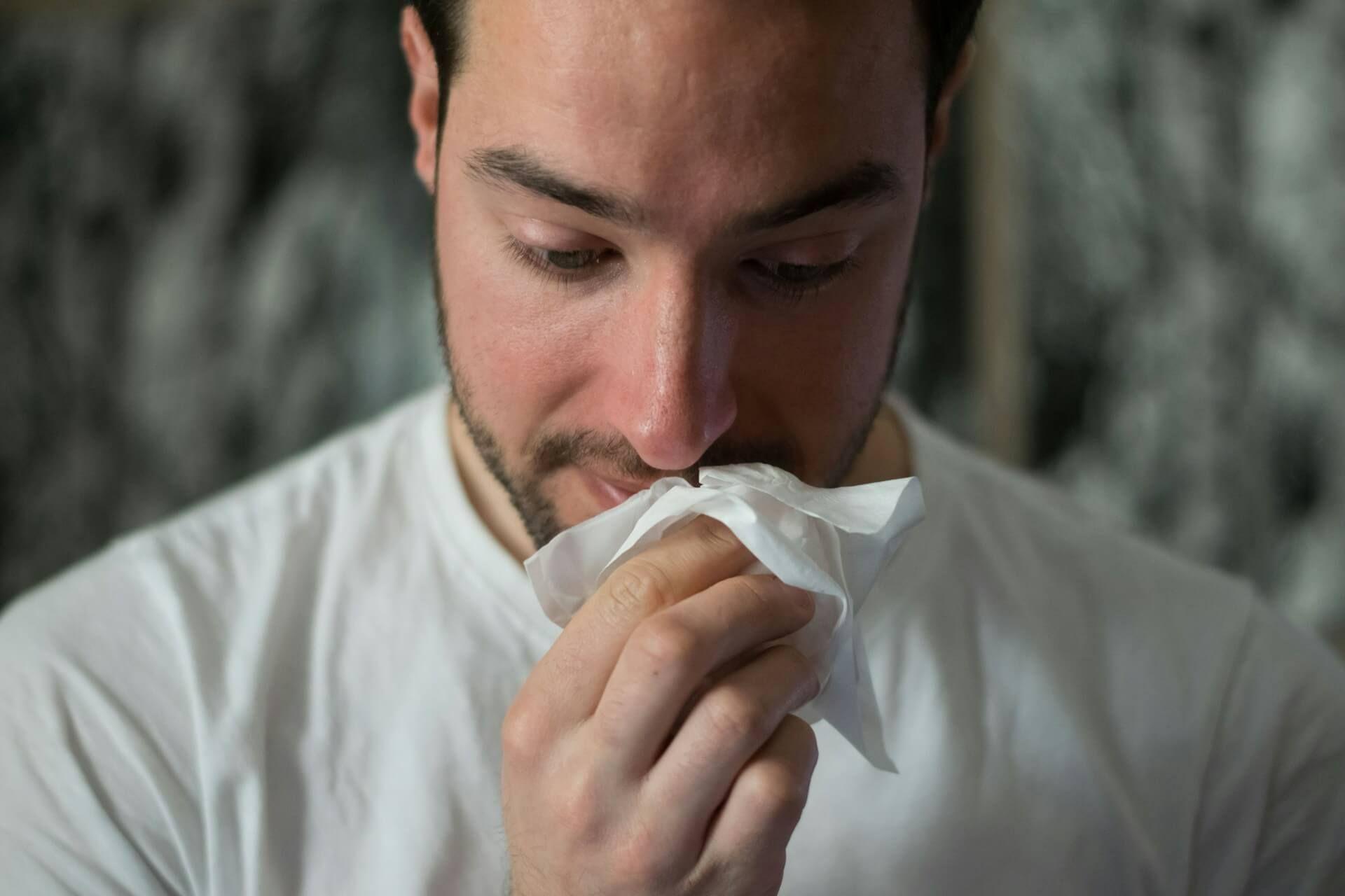 A person touching their nose symbolizing spiritual intuition and signs Photo - A person touching their nose symbolizing spiritual intuition and signs