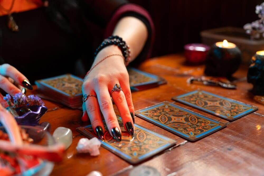 A set of tarot cards held in hands symbolizing spiritual reading and insight Photo - A set of tarot cards held in hands symbolizing spiritual reading and insight