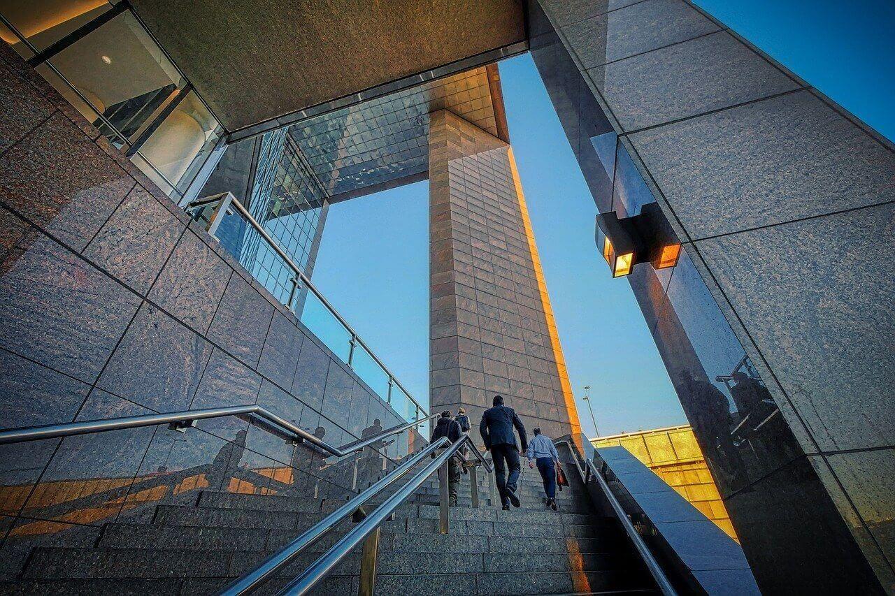 People walking up the skyscraper entrance stairs Photo - People walking up the skyscraper entrance stairs