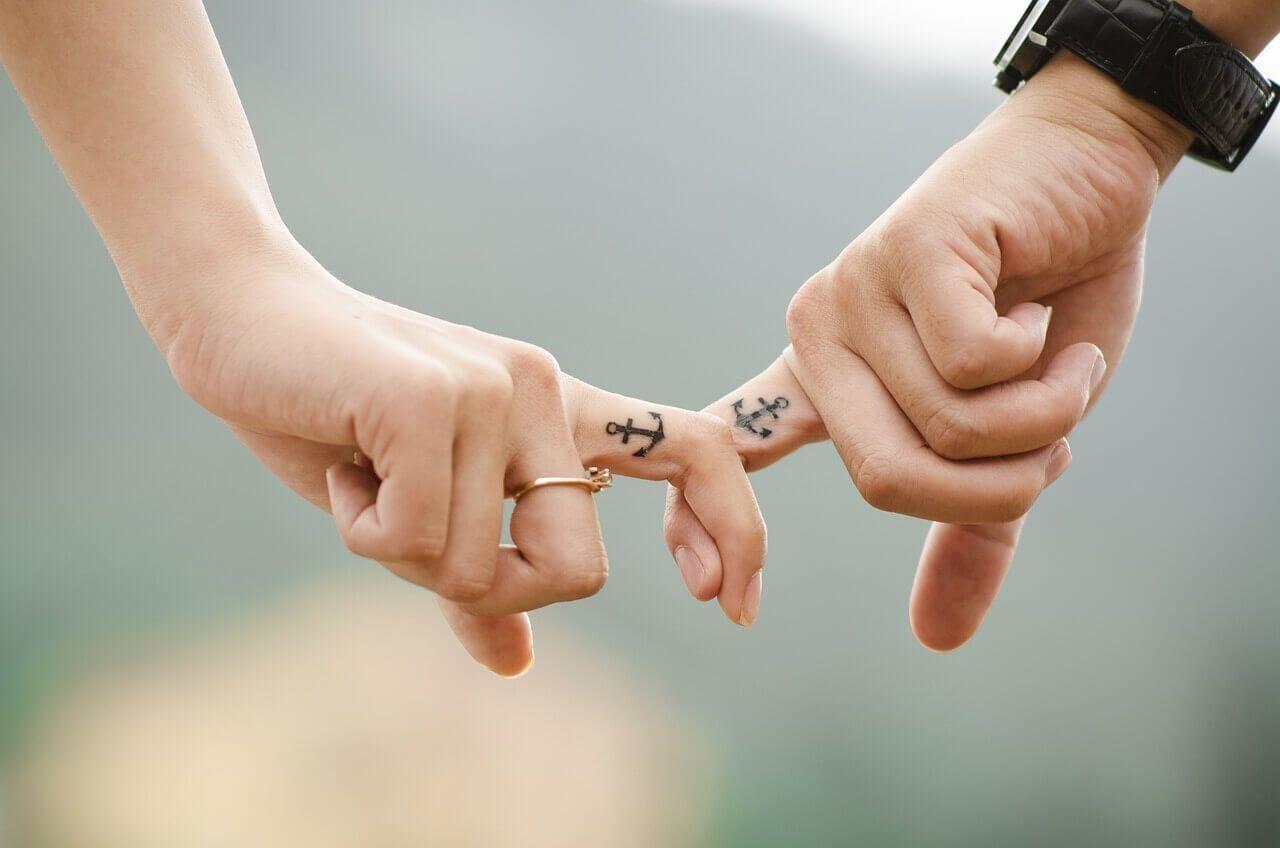 two people holding hands, holding each other by their index fingers Photo - two people holding hands, holding each other by their index fingers